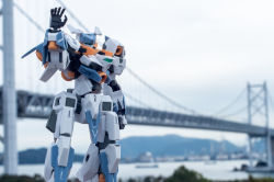 Rule 34 | baselard (frame arms), blurry, blurry background, bridge, clenched hand, frame arms, green eyes, looking at viewer, mecha, model kit, no humans, open hand, photo (medium), robot, solo, suzu (garage516), waving