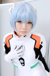 Rule 34 | 1girl, asian, ayanami rei, blue hair, breasts, color contacts, cosplay, hairpods, leaning forward, looking at viewer, makeup, mascara, namada, neon genesis evangelion, photo (medium), plugsuit, plugsuit (cosplay), short hair, small breasts, solo, standing