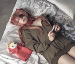Rule 34 | 1girl, bed, blue eyes, character name, cosplay, doll, evangelion: 3.0+1.0 thrice upon a time, eyepatch, frown, glico happy, hair ornament, hairclip, handheld game console, highres, hood, hooded jacket, jacket, long hair, lying, neon genesis evangelion, photo (medium), pillow, rebuild of evangelion, souryuu asuka langley, souryuu asuka langley (cosplay), white bed