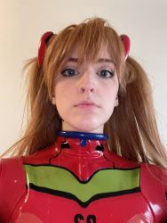 Rule 34 | 1girl, blue eyes, bodysuit, brazilian (nationality), breasts, brown hair, cosplay, expressionless, hairpods, highres, interface headset, lips, looking at viewer, memepantazis, neon genesis evangelion, photo (medium), plugsuit, red bodysuit, shiny clothes, solo, souryuu asuka langley, souryuu asuka langley (cosplay), standing, twintails, two side up