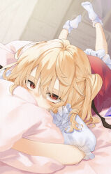 Rule 34 | 1girl, absurdres, bad anatomy, blonde hair, blush, calpis118, covered mouth, feet up, flandre scarlet, highres, hugging object, indoors, looking at viewer, lying, on stomach, one side up, pillow, pillow hug, red eyes, socks, touhou, white socks