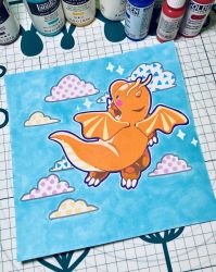 Rule 34 | acrylic paint (medium), animal focus, art tools in frame, blue background, blue eyes, blush, blush stickers, bottle, claws, cloud, creatures (company), dragonite, english text, flying, from behind, game freak, gen 1 pokemon, hand to own mouth, hand up, heart, highres, looking up, mazzlebee, midair, nintendo, no humans, outline, painting (medium), pawpads, photo (medium), pokemon, pokemon (creature), polka dot, solo, sparkle, traditional media, triangle, white outline