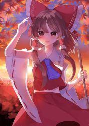 Rule 34 | 1girl, absurdres, arm up, ascot, autumn leaves, blue ascot, bow, brown eyes, brown hair, detached sleeves, hair bow, hair tubes, hakurei reimu, highres, leaf, long hair, looking at viewer, maple leaf, open mouth, outdoors, red skirt, ribbon-trimmed sleeves, ribbon trim, rori82li, shirt, skirt, smile, solo, touhou