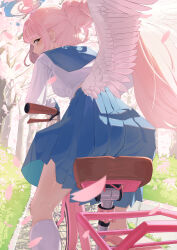 1girl absurdres bicycle blue_archive blue_sailor_collar blue_skirt blush feathered_wings from_behind from_below grass hair_between_eyes hair_bun highres long_hair looking_at_viewer mika_(blue_archive) petals pink_hair riding riding_bicycle rnjs4967 sailor_collar sidelocks skirt wings yellow_eyes