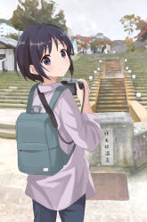 Rule 34 | 1girl, absurdres, backpack, bag, black hair, blue eyes, blurry, blurry background, blush, building, camera, chinosuke (cs4126), closed mouth, day, dot nose, female focus, highres, holding, holding camera, japanese text, kurosaki honoka, long sleeve shirt, long sleeves, looking at viewer, medium hair, outdoors, pants, scenery, sky, solo, stairs, standing, tree, yama no susume