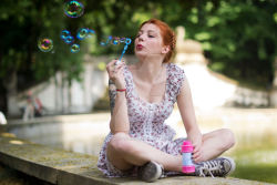 Rule 34 | 1girl, blurry, breasts, bubble, blowing bubbles, converse, cosplay, costume, day, depth of field, dolores haze (nabokov&#039;s lolita), dolores haze (nabokov&#039;s lolita) (cosplay), dress, indian style, nabokov&#039;s lolita, orange hair, outdoors, pale skin, photo (medium), red hair, river, shoes, short dress, short hair, sitting, small breasts, sneakers, soap bubbles, solo, tattoo, watermark