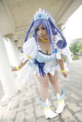 Rule 34 | 1girl, ankle boots, asian, bent over, blue eyes, blue hair, boots, bow, bracelet, breasts, choker, chouzuki maryou, cleavage, cosplay, cure diamond (cosplay), dokidoki! precure, dress, headpiece, highres, jewelry, large breasts, leaning forward, long hair, magical girl, matching hair/eyes, photo (medium), plump, ponytail, precure, puffy short sleeves, puffy sleeves, ribbon, short sleeves, solo, tiara