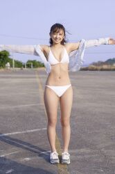 Rule 34 | 1girl, bikini, blurry, blurry background, highres, komiya arisa, looking at viewer, open clothes, open shirt, outdoors, outstretched arms, photo (medium), shoes, smile, sneakers, standing, swimsuit, t-pose, voice actor, white bikini