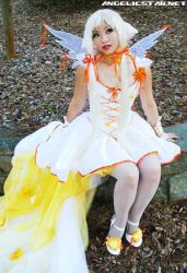 Rule 34 | angelicstar, blonde hair, bow, chii, chobits, clamp, cosplay, dress, lipstick, long dress, long hair, makeup, photo (medium), photo shoot, red lips, short twintails, twintails, wings, yaya han, yellow dress