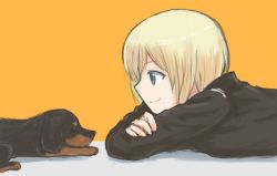Rule 34 | 1girl, blonde hair, blue eyes, crossed arms, dachshund, erica hartmann, lying, mutsu (layergreen), on stomach, short hair, smile, strike witches, world witches series, yellow background
