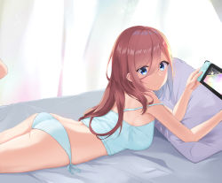 Rule 34 | 1girl, ass, bed, bed sheet, blue camisole, blue eyes, blue panties, breasts, camisole, controller, curtains, feet up, go-toubun no hanayome, hair between eyes, highres, holding, holding controller, light blush, light particles, long hair, looking at viewer, looking back, lying, medium breasts, nakano miku, nintendo switch, on bed, on stomach, panties, pillow, red hair, side-tie panties, sleeveless, smile, solo, strap slip, thighs, tiara (871220), underwear, underwear only