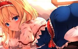 1girl, alice margatroid, ass, blonde hair, blue dress, blue eyes, blush, capelet, commentary request, dress, frilled capelet, frilled dress, frills, from behind, from side, frown, hair between eyes, hairband, highres, hunya, lolita hairband, looking at viewer, looking back, lying, medium hair, on stomach, pillow, pillow hug, red hairband, solo, touhou, wavy mouth, white capelet