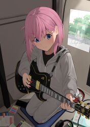 Rule 34 | 1girl, absurdres, black shirt, blue eyes, blush, bocchi the rock!, breasts, electric guitar, gotoh hitori, grey pants, guitar, hair over eyes, headphones, highres, holding, holding instrument, hood, hooded coat, instrument, jacket, kneeling, large breasts, music, nasai, pants, pink hair, playing instrument, seiza, shirt, sitting, solo, track jacket, track pants