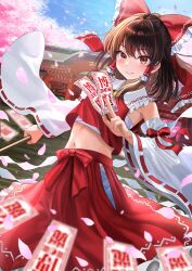 1girl ascot between_fingers blurry blush bow brown_eyes brown_hair cherry_blossoms commentary_request depth_of_field detached_sleeves falling_petals frilled_bow frilled_hair_tubes frills gohei hair_bow hair_tubes hakurei_reimu highres holding holding_gohei long_hair looking_at_viewer midriff navel ofuda ofuda_between_fingers petals pink_petals red_bow red_skirt ribbon-trimmed_sleeves ribbon_trim skirt skirt_set smile solo touhou uemura_shun yellow_ascot yin_yang yin_yang_print