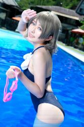 Rule 34 | 1girl, blue eyes, competition swimsuit, cosplay, cosplay photo, grey hair, highres, looking at viewer, love live!, love live! sunshine!!, mi yan 0728, on water, one-piece swimsuit, photo (medium), pool, salute, short hair, smile, standing, swim cap, swim goggles, swimsuit, watanabe you