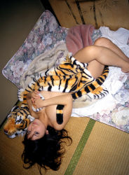 Rule 34 | 1girl, asian, black hair, blanket, breasts, cleavage, hanai miri, highres, indoors, long hair, looking at viewer, ns eyes 337, photo (medium), solo, stuffed animal, stuffed toy, tatami, tiger