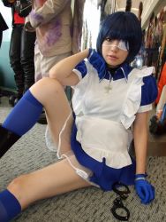 Rule 34 | 1girl, apron, asian, black footwear, blue eyes, blue gloves, blue hair, blue socks, boots, collar, color contacts, cosplay, cross, cuffs, dutch angle, eyepatch, gloves, handcuffs, ikkitousen, indoors, kneehighs, looking at viewer, maid, maid apron, namada, on floor, photo (medium), puffy short sleeves, puffy sleeves, reflection, ryomou shimei, ryomou shimei (cosplay), short sleeves, sitting, socks, solo focus
