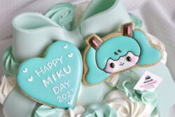 Rule 34 | 1girl, 2023, :&gt;, aqua bow, aqua hair, aqua theme, black eyes, blush stickers, bow, cake, character-themed food, closed mouth, commentary request, english text, food, food art (medium), food focus, hair ornament, hatsune miku, head only, heart, heart-shaped cookie, highres, long hair, miku day, pale skin, photo (medium), smile, solid oval eyes, solo, takakura (mug 0u0), twintails, unconventional media, vocaloid