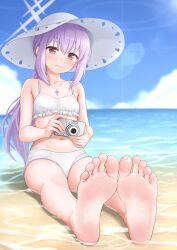 1girl atsuko_(blue_archive) atsuko_(swimsuit)_(blue_archive) barefoot beach blue_archive blush camera feet foot_focus hat highres hinosaki long_hair looking_at_viewer purple_hair red_eyes smile soles sun_hat swimsuit toes