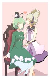 Rule 34 | 2girls, black headwear, bracelet, chair, closed eyes, closed mouth, commentary, dress, earmuffs, full body, ghost tail, green dress, green eyes, green hair, hat, heart, highres, holding hands, jewelry, looking at another, momitoekk, multiple girls, ofuda, ofuda on clothes, pink background, pointy hair, purple skirt, short hair, simple background, sitting, skirt, soga no tojiko, standing, tate eboshi, touhou, toyosatomimi no miko, yuri