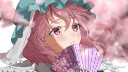 Rule 34 | 1girl, artist name, blue hat, blurry, blurry background, blurry foreground, cherry blossom print, cherry blossoms, fan over face, floral print, folding fan, frills, hand fan, hat, holding, holding fan, light blush, looking up, mob cap, mokou cooking, parted lips, pink eyes, pink hair, portrait, ribbon trim, saigyouji yuyuko, signature, solo, touhou