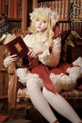 Rule 34 | 1girl, absurdres, adapted costume, black nails, blonde hair, book, bookshelf, closed mouth, cosplay photo, feet out of frame, flandre scarlet, hat, highres, holding, holding book, indoors, koiyume615, library, long sleeves, medium hair, mob cap, multicolored wings, nail polish, on chair, open book, pantyhose, petticoat, photo (medium), red eyes, red skirt, red vest, shirt, sitting, skirt, solo, touhou, vest, white hat, white pantyhose, white shirt, wings, wooden chair, wooden floor