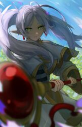 Rule 34 | 1girl, absurdres, blurry, blurry foreground, capelet, dangle earrings, drop earrings, earrings, elf, frieren, grass, green eyes, highres, holding, holding staff, jewelry, looking at viewer, m3ru, mage staff, outdoors, parted bangs, pointy ears, shirt, solo, sousou no frieren, staff, striped clothes, striped shirt, twintails, white capelet, white hair, wide sleeves