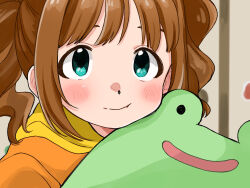 1girl aqua_eyes blush brown_hair close-up closed_mouth highres holding holding_stuffed_toy hood hood_down hoodie idolmaster idolmaster_(classic) looking_at_viewer medium_hair naruse_ill orange_hoodie solo stuffed_animal stuffed_frog stuffed_toy takatsuki_yayoi twintails