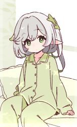 1girl commentary_request genshin_impact green_eyes green_pajamas highres long_hair looking_at_viewer nahida_(genshin_impact) on_bed pajamas pillow pointy_ears sitting solo white_hair yoru_nai