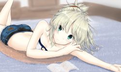 Rule 34 | 1girl, absurdres, arm rest, bare arms, bare shoulders, blonde hair, blurry, blurry background, book, breasts, closed mouth, collarbone, crop top, denim, denim shorts, eyes visible through hair, fate (series), green eyes, hair ornament, hair over one eye, highres, indoors, long hair, looking at viewer, lying, mordred (fate), mordred (fate/apocrypha), mordred (memories at trifas) (fate), on stomach, outstretched arm, ponytail, short shorts, shorts, simple background, sleeveless, small breasts, solo, strapless, uzuki tsukuyo