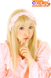 Rule 34 | 1girl, blonde hair, bonnet, choker, cosplay, cosplay photo, cosplex, dress, finger to mouth, frilled dress, frills, green eyes, highres, jewelry, lips, long hair, looking at viewer, maid headdress, necklace, parted lips, photo (medium), pink dress, puffy sleeves, real life, ribbon, shushing, simple background, solo, white background