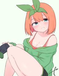 Rule 34 | 1girl, bare shoulders, black shorts, blue eyes, blush, breasts, cleavage, collarbone, commentary request, controller, eyebrows hidden by hair, feet out of frame, game controller, go-toubun no hanayome, green background, green hoodie, green ribbon, grin, hair between eyes, hair ribbon, head tilt, highres, holding, hood, hood down, hoodie, knees up, kujou karasuma, looking at viewer, medium breasts, nakano yotsuba, nintendo switch pro controller, off shoulder, orange hair, ribbon, short shorts, shorts, signature, simple background, smile, solo