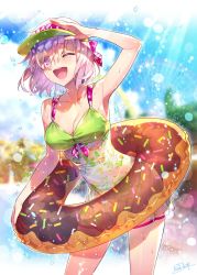 Rule 34 | 1girl, alternate costume, armpits, bare shoulders, bikini, blush, breasts, cleavage, collarbone, cowboy shot, doughnut innertube, dress swimsuit, eyes visible through hair, fate/grand order, fate (series), floral print, green bikini, hair over one eye, hand up, highres, innertube, large breasts, lens flare, light purple hair, looking at viewer, mash kyrielight, navel, one eye closed, open mouth, outdoors, purple eyes, redrop, short hair, smile, solo, sparkle, sunlight, swim ring, swimsuit, thighs, visor cap, water
