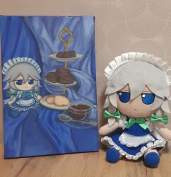 Rule 34 | 1girl, :&lt;, apron, blue skirt, blue vest, bow, bowtie, braid, character doll, closed mouth, commentary, cookie, cup, english commentary, food, full body, fumo (doll), green bow, green bowtie, grey hair, hair between eyes, hair bow, highres, izayoi sakuya, looking at viewer, macaron, maid, maid headdress, marina killer red, medium bangs, medium hair, painting (medium), photo (medium), saucer, sitting, skirt, skirt set, tea, teacup, touhou, traditional media, twin braids, vest, waist apron, white apron