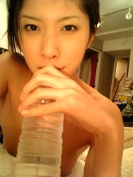 Rule 34 | 1girl, asian, blanket, bottle, highres, indoors, looking at viewer, no shirt, photo (medium), solo, tachibana riko, water bottle