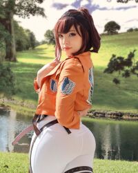 Rule 34 | ass, belt, brown eyes, brown hair, closed mouth, cosplay, female focus, highres, huge ass, jacket, looking at viewer, looking back, matching hair/eyes, military jacket, missbrisolo, outdoors, pants, real life, red lips, river, sasha blouse, sasha blouse (cosplay), shingeki no kyojin, smile, solo, standing, survey corps (emblem), white pants