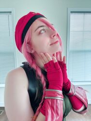 Rule 34 | 1girl, bare shoulders, blue eyes, braid, cammy white, cammy white (cosplay), cosplay, fingerless gloves, gloves, hat, highres, indoors, leotard, long hair, looking up, musclemommycosplay, photo (medium), pink hair, real life, shiny clothes, sleeveless, smile, street fighter, twin braids