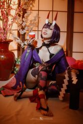 Rule 34 | 1girl, absurdres, artist request, barefoot, cosplay, fate/grand order, fate (series), female focus, highres, horns, indoors, japanese clothes, kimono, looking at viewer, medium hair, oni, photo (medium), purple hair, shiny skin, shuten douji (fate), skin-covered horns, solo, teeth, toes