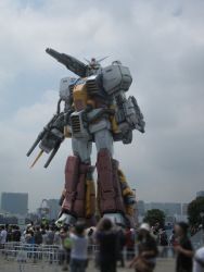 Rule 34 | 6+boys, arms at sides, blurry, cannon, cloud, cloudy sky, depth of field, gundam, kou (mechalog), looking at viewer, male focus, mecha, multiple boys, no humans, outdoors, perfect gundam, plamo-kyo shiro, reactive armor, realistic, robot, size difference, sky, solo, standing, taking picture, yellow eyes