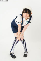 Rule 34 | 1girl, artist name, asian, black footwear, blue eyes, blue overalls, brown hair, character request, color contacts, cosplay request, full body, hands on own knees, hat, highres, knees together feet apart, leaning forward, looking at viewer, mary janes, namada, overall shorts, overalls, photo (medium), pigeon-toed, shoes, short sleeves, shorts, simple background, solo, standing, striped clothes, striped thighhighs, thighhighs, watch, white background, white hat, wristwatch, zettai ryouiki