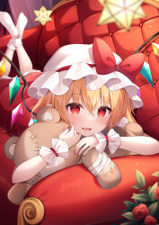 Rule 34 | 1girl, black eyeliner, blonde hair, bow, couch, crystal, cuffs, dress, eyelashes, eyeliner, flandre scarlet, flower, frilled cuffs, frills, hat, hat bow, hat ribbon, highres, hug, looking at viewer, lying, makeup, miy@, mob cap, on stomach, one side up, open mouth, red bow, red dress, red eyes, red flower, red rose, ribbon, rose, short hair, side ponytail, small stellated dodecahedron, smile, solo, stuffed animal, stuffed toy, teddy bear, touhou, white hat, wings, wrist cuffs