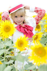Rule 34 | 1girl, apron, ashita no nadja, asian, blonde hair, blurry, boater hat, bow, cosplay, depth of field, flower, frills, hat, kipi-san, long hair, looking at viewer, mole, nadja applefield, nadja applefield (cosplay), outdoors, photo (medium), solo, standing, sunflower