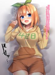 Rule 34 | 1girl, ^^^, bad id, bad pixiv id, bed sheet, blue eyes, breasts, brown hair, brown hoodie, brown shorts, clothes writing, collarbone, commentary request, cowboy shot, fang, go-toubun no hanayome, green ribbon, hair between eyes, hair ribbon, hands up, highres, hood, hood down, hoodie, large breasts, long sleeves, looking at viewer, lying, nakano yotsuba, on back, open mouth, ramchi, ribbon, short shorts, shorts, sleeves past wrists, solo, sweat, translated