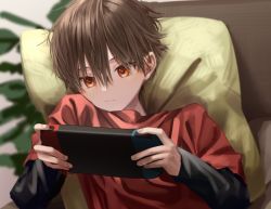 Rule 34 | 1boy, aimai sheena, brown hair, brush stroke, child, closed mouth, commentary, eyebrows hidden by hair, faux traditional media, from above, game console, hair between eyes, holding, indoors, long sleeves, looking at object, lying, male focus, nintendo switch, on back, original, pillow, red eyes, red shirt, shirt, short hair, solo, symbol-only commentary