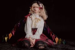 Rule 34 | absurdres, adapted costume, artist name, bad id, bad twitter id, black pantyhose, blonde hair, bow, bowtie, brooch, closed mouth, cosplay photo, dark background, earrings, flandre scarlet, full body, highres, indoors, jewelry, long sleeves, multicolored wings, no vest, one side up, own hands together, pantyhose, photo (medium), pointy ears, red brooch, red eyes, red skirt, shirt, sitting, skirt, tartetatin0516, touhou, wariza, white shirt, wings, yellow bow, yellow bowtie