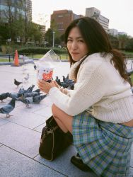 Rule 34 | 1girl, asian, kawamura yuki, looking at viewer, looking back, miniskirt, outdoors, photo (medium), pigeon, pleated skirt, skirt, solo, squatting, sweater, tagme