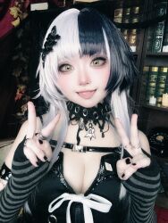 Rule 34 | 1girl, absurdres, black hair, black nails, book, breasts, cosplay, detached sleeves, fingerless gloves, gloves, highres, hololive, hololive english, jewelry, large breasts, latex, long hair, m/, multicolored hair, photo (medium), real life, ring, shiori novella, smile, taotan1412, tongue, tongue out, two-tone hair, v, virtual youtuber, w, white hair, yellow eyes