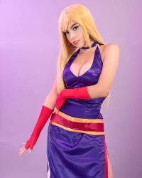 Rule 34 | 1girl, bare shoulders, blonde hair, breasts, cleavage, cosplay, dress, fatal fury, fingerless gloves, garou: mark of the wolves, gloves, highres, jenet behrn, jenet behrn (cosplay), karen g, large breasts, long hair, looking at viewer, mexican (nationality), photo (medium), real life, sleeveless, the king of fighters