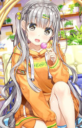Rule 34 | 1girl, :d, blurry, blurry background, blush, bow, braid, candy, clothes writing, collarbone, commentary request, crown braid, depth of field, food, fujima takuya, grey eyes, grey hair, hair bow, hair ornament, hairclip, holding, holding candy, holding food, holding lollipop, hood, hood down, hoodie, indoors, knee up, lollipop, long hair, long sleeves, looking at viewer, one side up, open mouth, orange hoodie, original, plant, potted plant, sitting, sleeves past wrists, smile, solo, star (symbol), very long hair, yellow bow