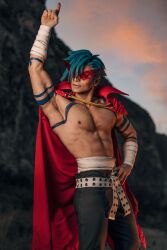 Rule 34 | 1boy, abs, arm tattoo, armpits, bandaged arm, bandages, belt, black pants, blue hair, blurry, blurry background, cape, closed mouth, cosplay photo, cowboy shot, hand on own hip, hand up, highres, kamina (ttgl), looking at viewer, male focus, mountain, muscular, muscular male, nipples, pants, pectorals, photo (medium), pointing, pointing up, red-framed eyewear, red cape, short hair, sky, solo, taryn cosplay, tattoo, tengen toppa gurren lagann, topless male, white belt